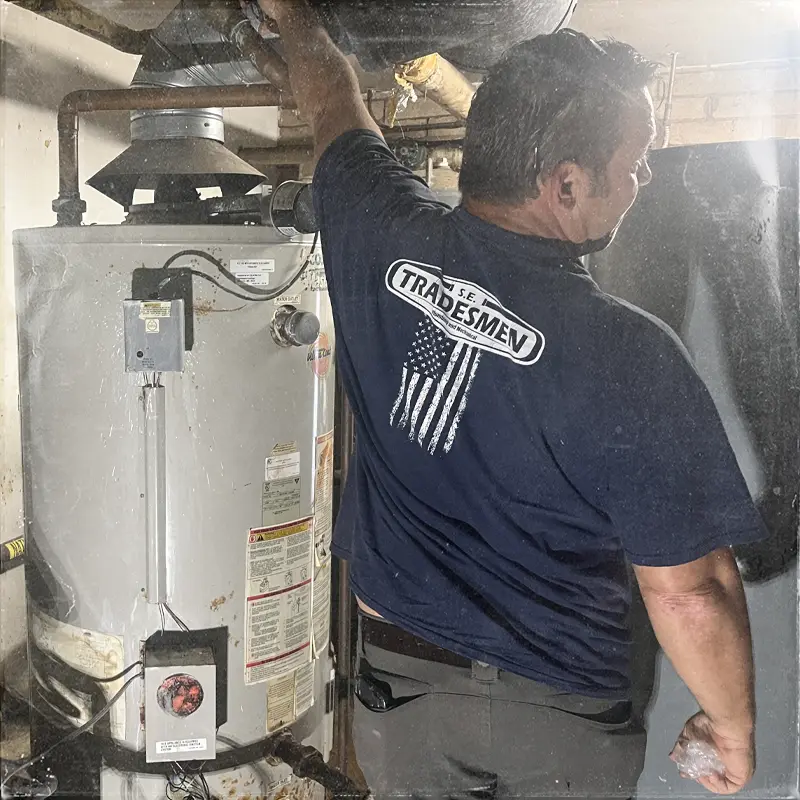 A plumber troubleshoots a water heater.
