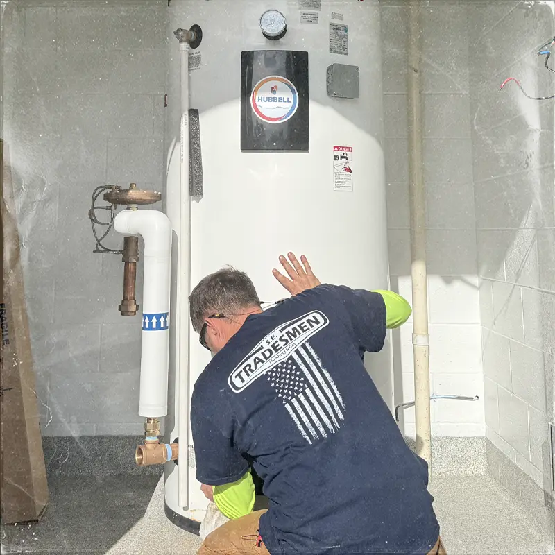 A plumber installs a water heater.