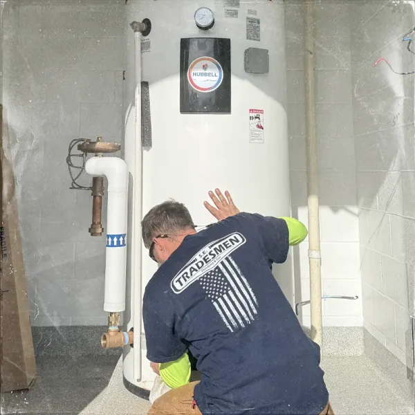 A plumber installs a water heater.